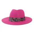 Detail shot of pink fedora straw hat with colorful paisley band for summer beach and travel. - Rose Red