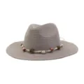Detail view of a stylish gray straw fedora hat featuring a woven rope and beaded band, perfect for summer. - Gray
