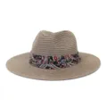 Detailed view of summer straw fedora hat featuring colorful paisley ribbon band for sun protection. - Dusty Pink