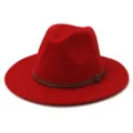 Detail view of a vibrant red wool fedora hat featuring a brown leather strap. - 58cm / Red
