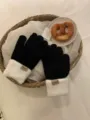 Winter black white knit gloves close-up detail, cozy fleece cuff design, warm cozy style. - Black