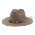 Vue détaillée du chapeau de paille à large bord avec bande tressée de perles colorées. - Vieux rose
