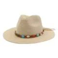 Vue détaillée d'un chapeau de paille d'été à large bord avec bande de perles colorées. - Beige