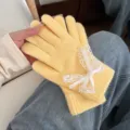 Cute women's winter knit gloves featuring yellow wool and sweet white lace bow design for warm wear. - Yellow