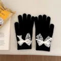 Black knit gloves for women featuring a cute white lace bow, perfect for winter warmth and daily wear. - Black