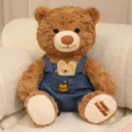Cute brown teddy bear plush toy wearing blue denim overalls with honey pot embroidery gift. - 25cm / Denim Overalls
