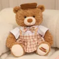 Cute brown teddy bear plush toy with stylish hat and plaid skirt, ideal gift for girlfriend. - Couple Bear Female Style