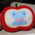 Cute red apple plush pillow with cartoon blue elephant design for sofa home decor. - Elephant