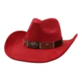 Red suede cowboy hat detail shot showcasing bull skull emblem, decorative band and wide brim. - Red