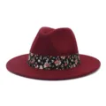 Vista detallada de sombrero fedora de fieltro rojo vino con elegante cinta floral negra. - 58cm / Burdeos