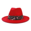 Detail view of red wool felt fedora hat featuring a stylish black floral patterned band. - 58cm / Red