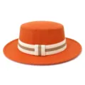 Close-up detail of the stylish orange flat top wool fedora hat with contrast striped ribbon band. - 58cm / Orange Yellow