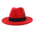 Detailed view of the red wool felt fedora hat with black band and elegant feather trim. - 58cm / Red
