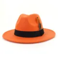 Orange woolen fedora hat detail, showing smooth felt texture, black ribbon band and feather decor. - 58cm / Orange