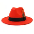 Red wool fedora hat for women and men, classic jazz cap with black band and feather decoration. - 58cm / Orange