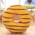 Soft plush donut pillow with chocolate stripes, ideal for home decoration and cozy nap time. - Lemon Prince
