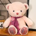 Lindo osito de peluche rosa con bufanda de punto morada y adorno floral, muñeca suave abrazable. - Rosa / Altura del asiento 35 cm