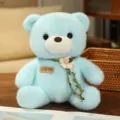 Cute light blue plush teddy bear toy with floral garland and tag, perfect cuddly gift for kids. - Sky Blue Bear with Cotton Flower