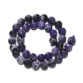 Close-up detail of faceted purple fire agate gemstone beads for DIY jewelry making and crafting. - Purple