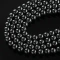 Close-up detail of black hematite magnetic round beads, perfect for DIY jewelry making. - 4mm (Approx 102 Pieces) / Black