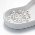 Nahaufnahme glänzender Perlenanhänger mit goldenen Schlaufen für DIY Schmuck und Accessoires - Runde Form (AC4889) / 4*7mm (10 Stück/Packung) / 14K-Gold