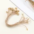 Detail shot of natural jute style hang tag string with plastic snap lock for garment labels. - 20-Piece Pack / Brown