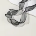 Close-up detail of black sheer organza ribbon with delicate white pearl beaded edge. - 1 Meter Pack / Black