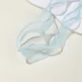 Close up view of light blue organza ribbon with delicate pearl edges, ideal for DIY crafts. - Sky Blue