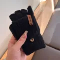 Detailed view of black knit half finger gloves with chic brown tag and warm winter design texture. - Black