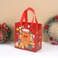 Bolsa de compras navideña roja de tela no tejida con hombre de jengibre para regalos. - Hombre de jengibre / 22x23x11cm
