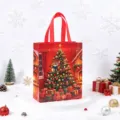 Red Christmas non-woven gift bag with festive tree print for holiday present packaging. - Christmas Tree / 26x32x10cm