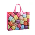 Vibrant colorful macaron print detail on durable non-woven shopping tote bag with pink handles. - Macarons