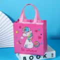 Pink non-woven gift bag featuring cute unicorn cartoon and text, ideal for clothing and retail packaging. - Pink