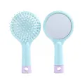 Detailed view of cute round hair brush with mirror and massage cushion in light blue style. - Hair Comb with Mirror - Blue