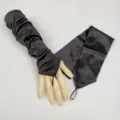 Detail view of black satin long fingerless gloves, elegant armwear for evening parties and stage. - Black