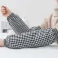 Detailed view of black and white plaid oversleeves with comfortable elastic cuffs for daily use. - Plaid Oversleeves - Black