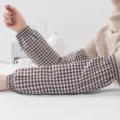 Detail shot of brown gingham cotton oversleeves, showing elastic cuffs and fabric texture. - Plaid Oversleeves - Coffee