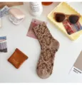 Retro floral knit mid-tube socks in coffee brown, featuring 3D embossed vintage style. - One Size / Coffee
