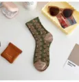 Retro vintage green mid-calf socks with brown embossed pattern and yellow dot details. - One Size / Green