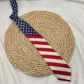 Close-up detail of the classic US flag pattern necktie, featuring stars and stripes design. - Stars and Stripes