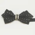 Detailed shot of men's black pointed bow tie featuring diamond pattern fabric and rhinestone center. - LJ-ZJ07