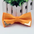 Orange men's adult bow tie featuring jacquard fabric, silver dots, and gold metal corners. - Orange