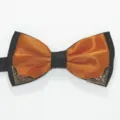 Close-up detail shot of the elegant men's two-tone bow tie with metallic corner decor. - Orange