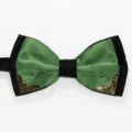 Detail shot of a green and black double layer bow tie featuring vintage metal decorative corners. - Verdant