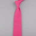 Primo piano di una cravatta lavorata a maglia rosa vivo da uomo con trama fine e punta. - Rosso Rosa
