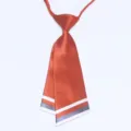 Detail view of a Korean style rust orange double layer knife shape necktie with striped trim. - Red