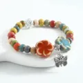 New Chinese style ceramic bead bracelet with colorful flower charms and silver butterfly pendant. - CS016 Blooming Flowers and Butterfly Dream (Orange and Blue)