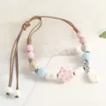 Handmade ceramic beaded bracelet with pastel floral charms and adjustable woven cord. - Leaf & Pink Plum Blossom