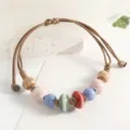 Handmade ceramic bead bracelet with woven brown cord, retro ethnic style couple jewelry variant. - Small UFO Red & Blue Style