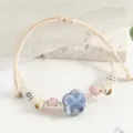 Handmade ceramic flower beaded bracelet with blue floral charm and beige woven cord for women. - Double Plum Blossom Purple and Beige